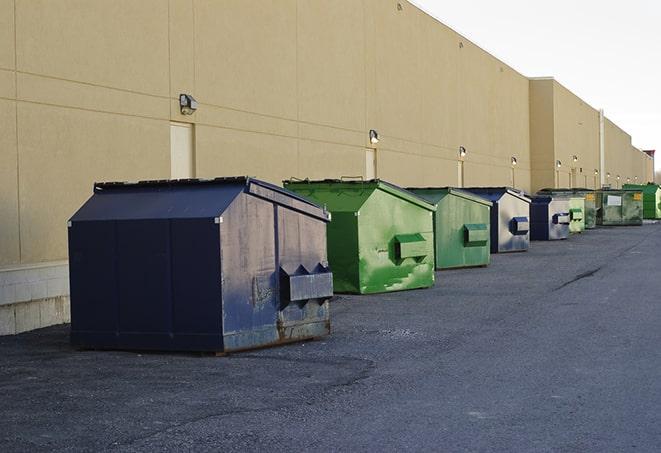 a fleet of red and blue construction dumpsters available for use in Browns Valley CA